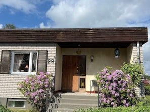 A two-story building with a brick facade, a wooden door, and a number '29' on the wall. - 4 Star Holiday Home in Karlsborg (Karlsborg)