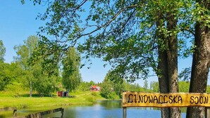 A wooden sign with "ŁIDNOWALESKA SOJON" written on it, a wooden dock, and a small red building in the background. - 4 Star Holiday Home in Karlskrona (Karlskrona)