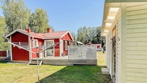 A red house with a porch and a fenced area. - 6 Person Holiday Home in Virserum (Virserum)
