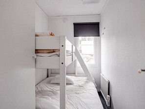 A bunk bed room with a window and a radiator. - 6 Person Holiday Home in Virserum (Virserum)