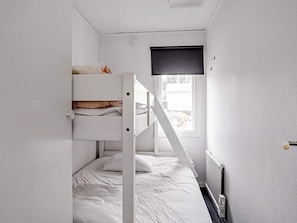 A bunk bed room with a window and a radiator. - 6 Person Holiday Home in Virserum (Virserum)