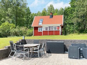A red house with a tiled roof, a chimney, and a window. - 4 Star Holiday Home in Osby (Osby)