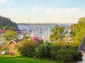 A marina with boats docked, surrounded by greenery and a small building. - 4 Star Holiday Home in Myggenas (Myggenäs)