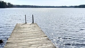 A wooden pier extending into a calm lake with a forested shoreline in the background. - 4 Person Holiday Home in Holmsjo (Holmsjö)