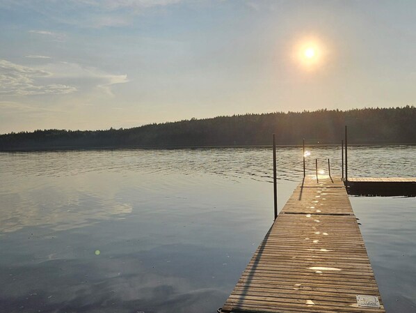 A wooden pier extending into a calm lake with a forested hill in the background. - 4 Person Holiday Home in Holmsjo (Holmsjö)