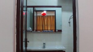 A bathroom with a white sink, a mirror, and a shower. - Youxi Sanming Red Lantern Hotel (Youxi)
