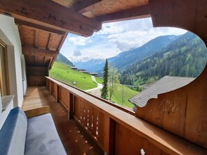 A balcony with a wooden railing overlooking a mountainous landscape. - Holiday Home in Finkenberg With Terrace (Finkenberg)