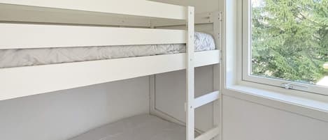 A bunk bed with a window on the right side.