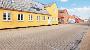 A yellow building with a tiled roof and white windows. - 5 Person Holiday Home in Albaek (Aalbaek)