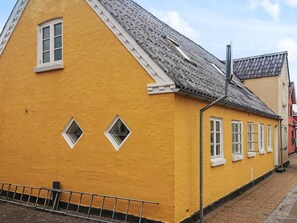 A yellow building with a sloped roof and multiple windows. - 5 Person Holiday Home in Albaek (Aalbaek)