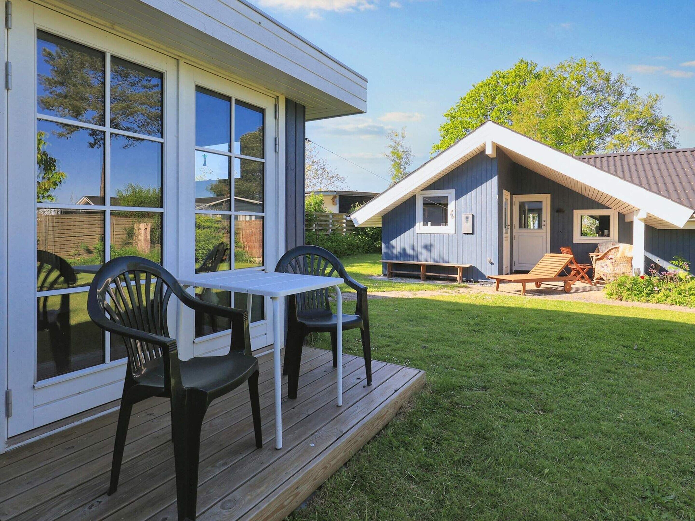 A modern house with a deck and outdoor seating area.