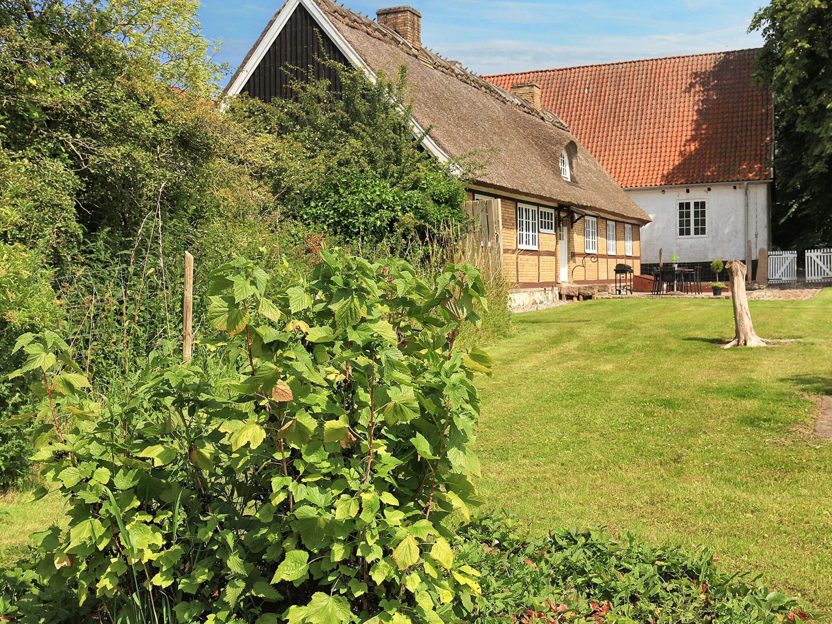 A traditional building with a thatched roof and a white facade.