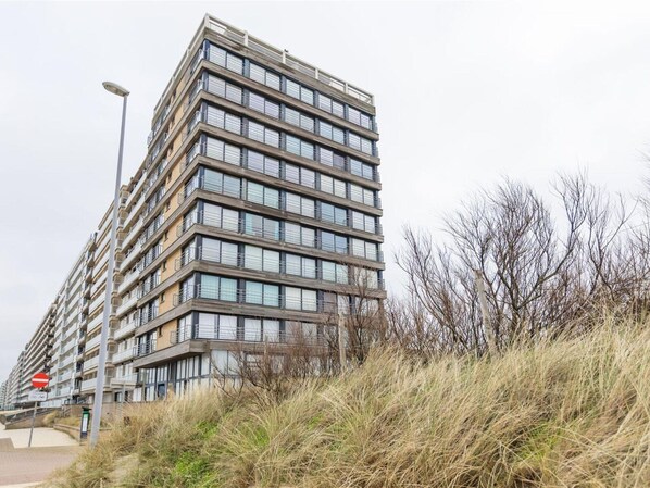 A modern high-rise building with multiple balconies and large windows. - Studio Apartment in Seaside With Panoramic Views (Middelkerke)