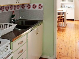 A kitchen with a sink, a Bosch stove, and a patterned backsplash.