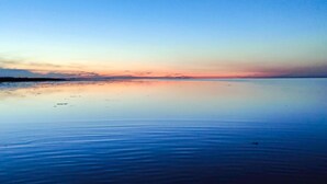 A calm body of water reflecting a sunset sky. - 8 Person Holiday Home in Hadsund (Hadsund)