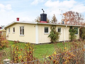 A single-story house with a gabled roof, a chimney, and a fenced yard. - 4 Star Holiday Home in Mellbystrand (Mellbystrand)