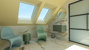A modern bathroom with skylights, marble flooring, and a large mirror. - Energy-neutral Villa for 2 People (Oudeschild)