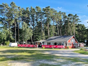 A red building with a sign that reads 'Norje Havskrog' in front of a forest. - 4 Star Holiday Home in Solvesborg (Sölvesborg)