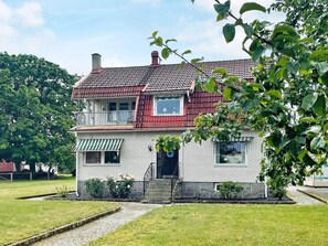 A two-story house with a red roof, a balcony, and a front porch. - 4 Star Holiday Home in Solvesborg (Sölvesborg)