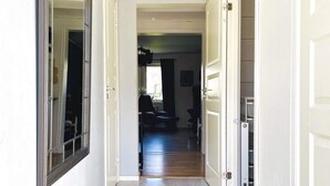 A hallway with a door leading to a room with a window, a chair, and a table. - 4 Person Holiday Home in Dals Rostock (Dals Rostock)