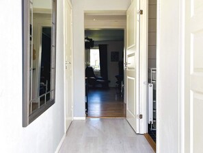 A hallway with a door leading to a room with a window, a chair, and a table. - 4 Person Holiday Home in Dals Rostock (Dals Rostock)