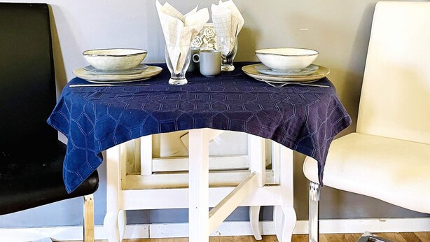 A dining table with plates, bowls, and a glass set. - 4 Person Holiday Home in Dals Rostock (Dals Rostock)