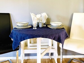 A dining table with plates, bowls, and a glass set. - 4 Person Holiday Home in Dals Rostock (Dals Rostock)
