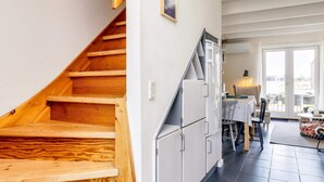 A staircase leading to a dining area with a view of the outdoors. - 6 Person Holiday Home in Hadsund (Hadsund)