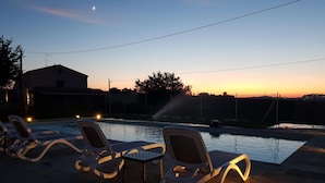 A swimming pool with lounge chairs and a sunset in the background. - Farmhouse Tent in Fermo Near Adriatic Sea (Fermo)