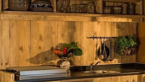 A kitchen with wooden cabinets, a stainless steel sink, and various kitchen utensils and appliances. - Farmhouse Tent in Fermo Near Adriatic Sea (Fermo)