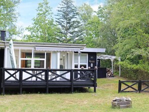 A cabin with a deck, a covered porch, and a number sign indicating its location. - 6 Person Holiday Home in Hadsund (Hadsund)