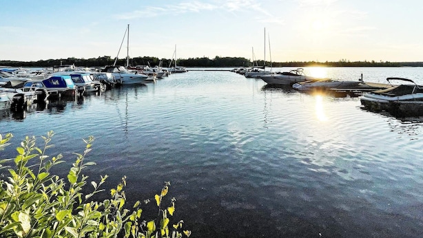 A marina with boats docked, calm water, and a clear sky. - 4 Star Holiday Home in Ljungby (Ljungby)