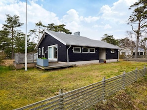 A modern two-story house with a dark exterior, a sloped roof, and a front porch. - 7 Person Holiday Home in Mellbystrand (Mellbystrand)