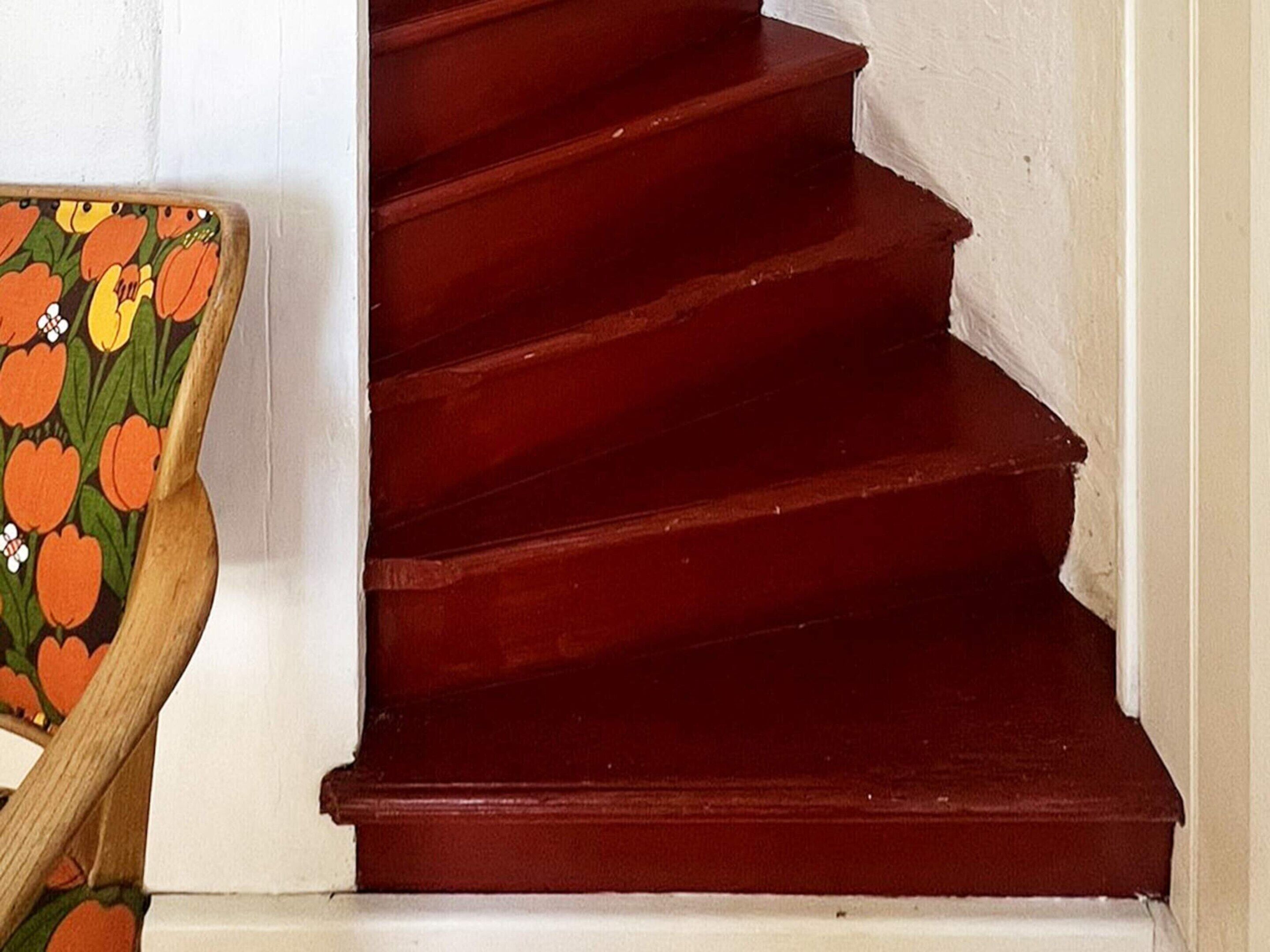 A staircase with dark wooden steps and a handrail.