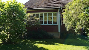 A house with a tiled roof, a chimney, and a window. - 5 Person Holiday Home in Hedekas (Hedekas)
