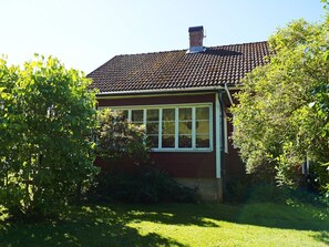 A house with a tiled roof, a chimney, and a window. - 5 Person Holiday Home in Hedekas (Hedekas)