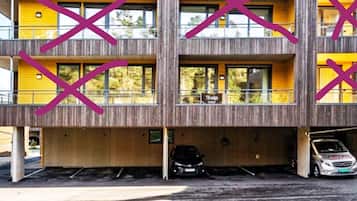 A modern building with a yellow facade and large windows.
