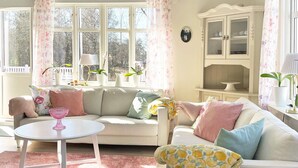 A cozy living room with a sofa, a round table, and a cabinet. - 4 Person Holiday Home in Herrljunga-by Traum (Herrljunga)