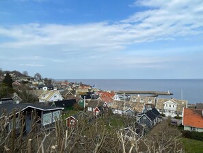 A coastal town with houses, a pier, and a clear sky. - 4 Star Holiday Home in Farhult (Hoganas)
