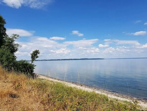 A calm lake with a clear sky and a distant shoreline. - 6 Person Holiday Home in Brenderup Fyn (Middelfart)