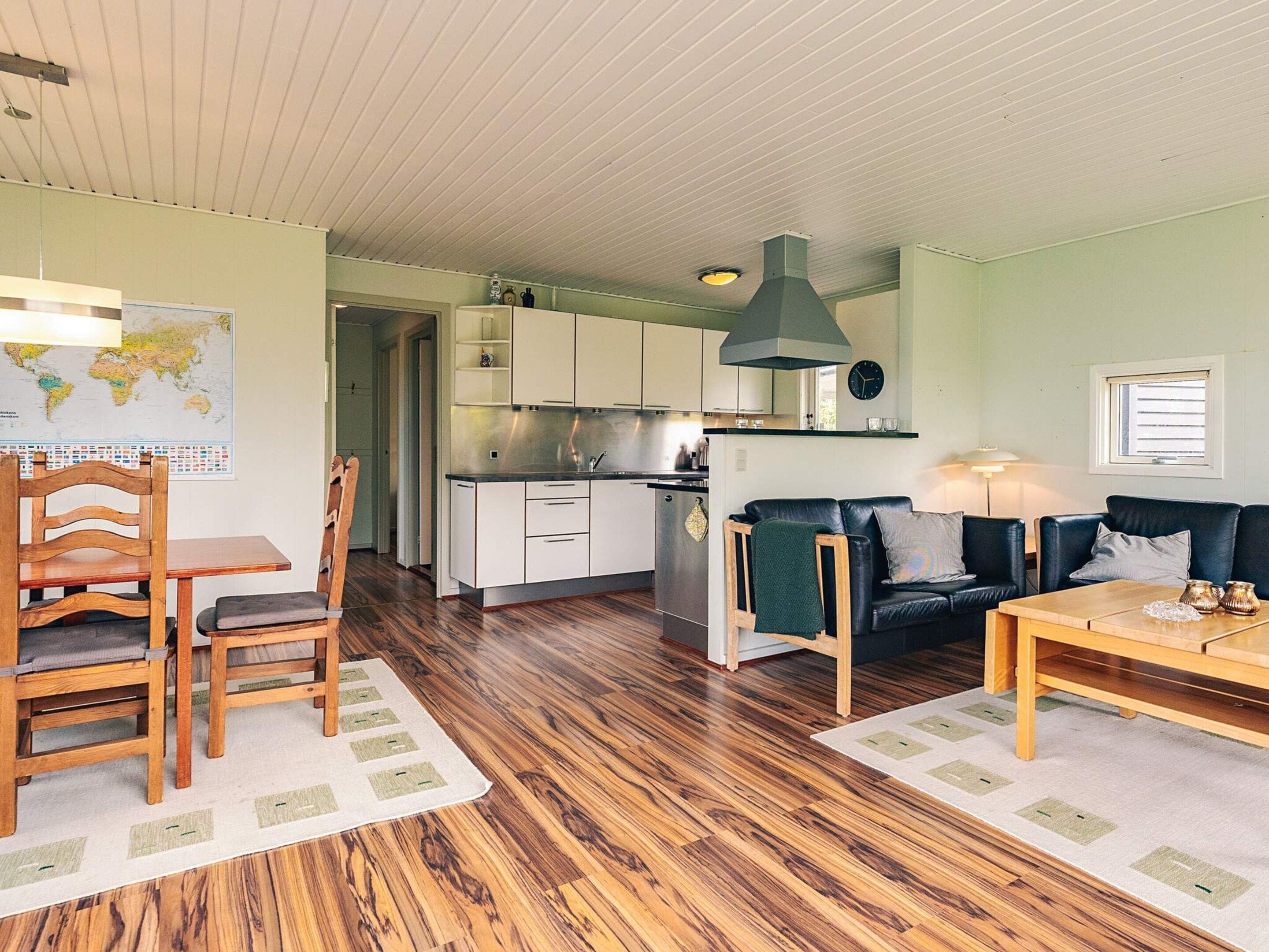 A compact living space with a kitchenette, dining area, and seating.