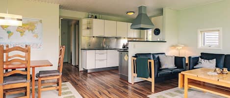 A compact living space with a kitchenette, dining area, and seating.