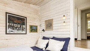 A bedroom with a bed, two pillows, a bedside table, and wall-mounted lights. - 6 Person Holiday Home in Brenderup Fyn (Middelfart)