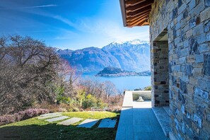A stone building with a view of a lake and mountains. - La Grande Beauté, a beautiful property with an incredible view of Lake Como (Lombardia)