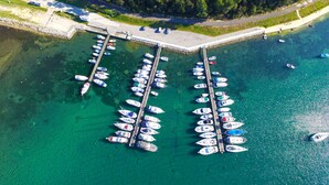 An aerial view of a marina with numerous boats docked at piers. - Holiday apartment with terrace (Vinkuran)
