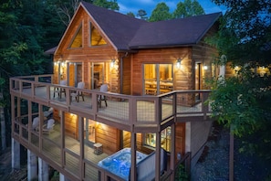A wooden cabin with a hot tub, deck, and multiple seating areas. - Luxury 3 2 5 Cabin Lake Views Theatre Gameroom (Bryson City)