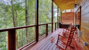 A wooden deck with a view of a forest. - 5 Master Suites 5 6bath Cabin 5 min to Gsmnp (Gatlinburg)