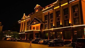 A building with a classic architectural style, featuring a prominent entrance with a decorative arch and a series of windows. - Tianyue Hotel (Fuyun)