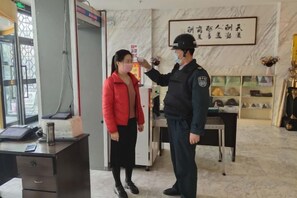 A reception area with a desk, a chair, and a framed sign on the wall. - Tianyue Hotel (Fuyun)