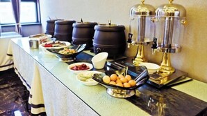 A buffet setup with various food items, including fruits, eggs, and condiments. - Tianyue Hotel (Fuyun)